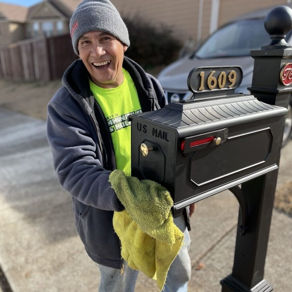 Photo of maintenance worker cleaning up a mailbox.